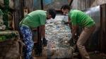Two employees work collecting plastics